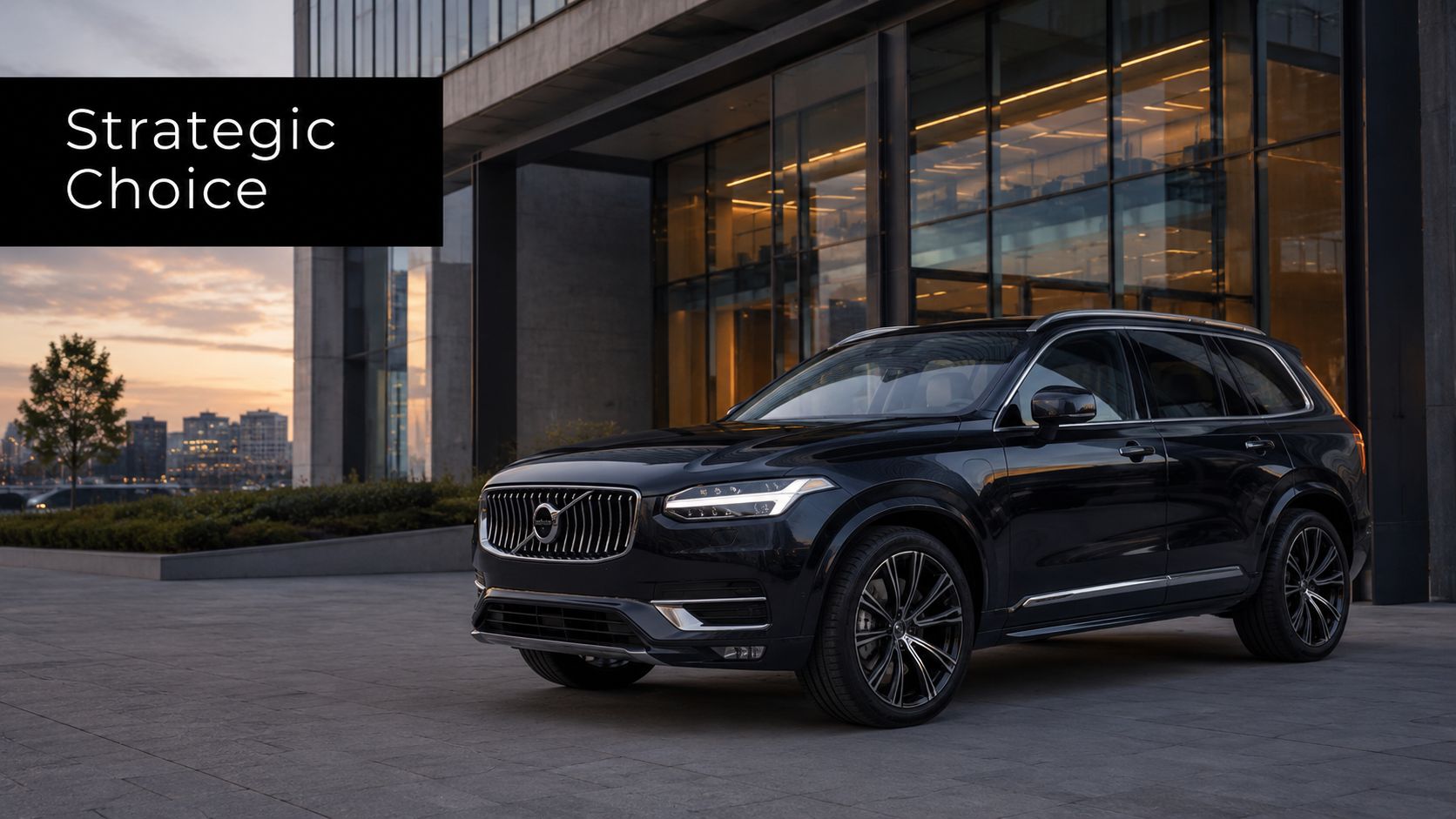 A sleek, black Volvo SUV parked on a modern stone plaza in front of a glass building.